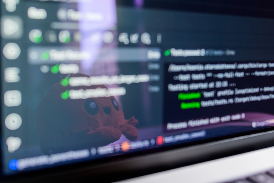 Computer screen displaying code with a toy reflected.